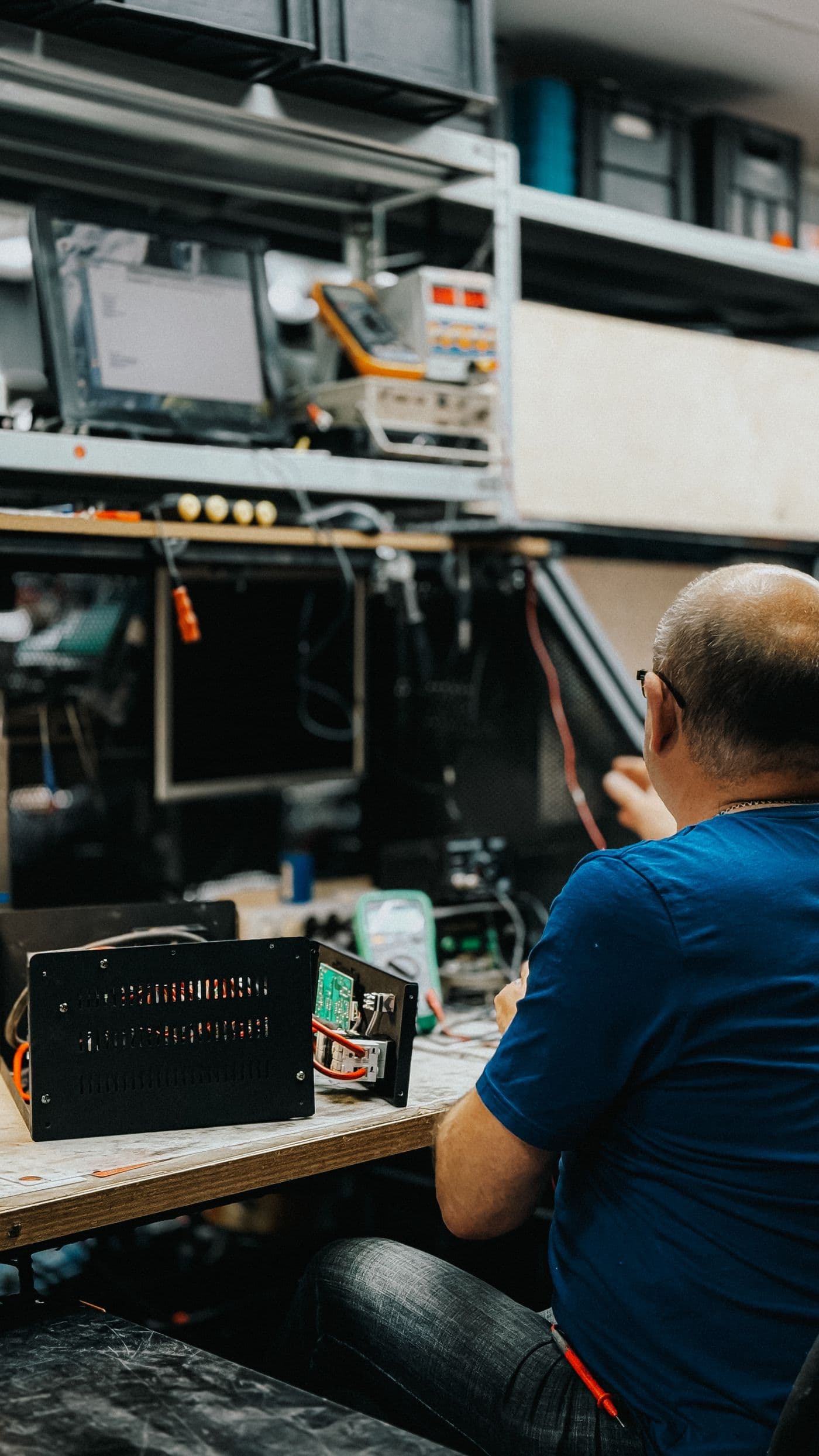 Person working on electronic repairs in a workshop