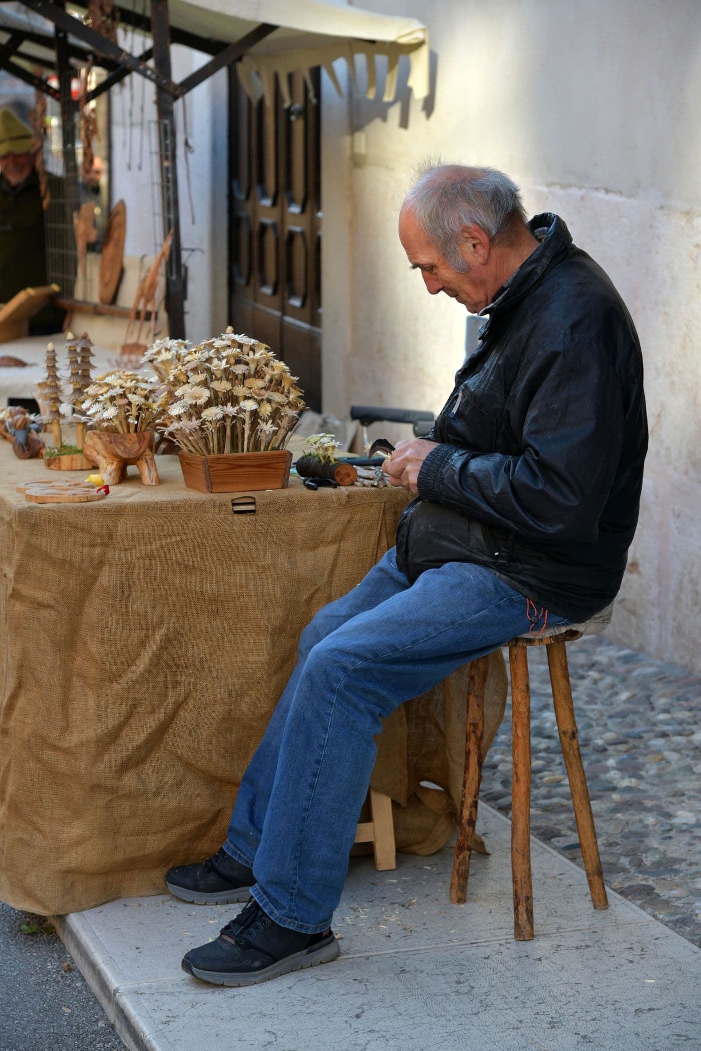 Craft seller working at a market stall