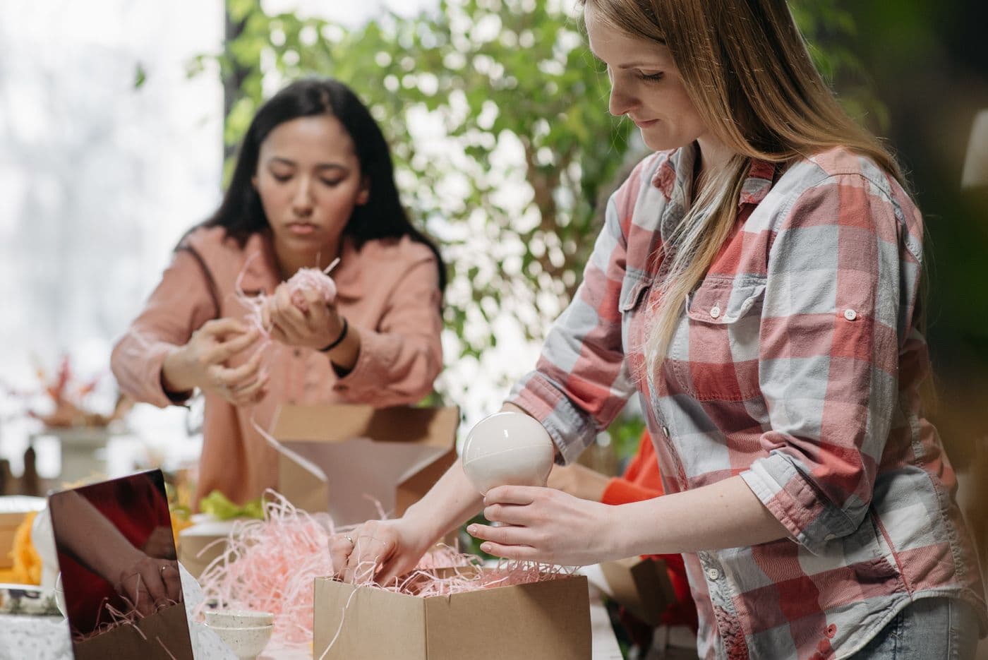 People packing orders into cardboard boxes