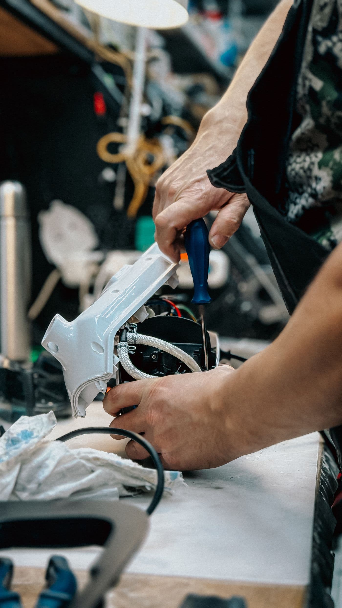 Técnico a reparar um equipamento eletrónico, visto de perto
