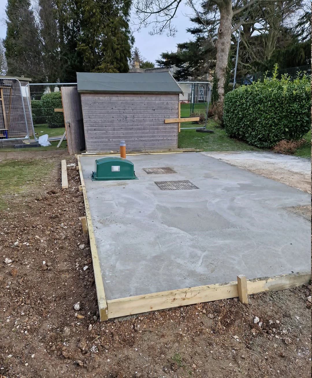 Completed wastewater installation with access covers and above-ground equipment