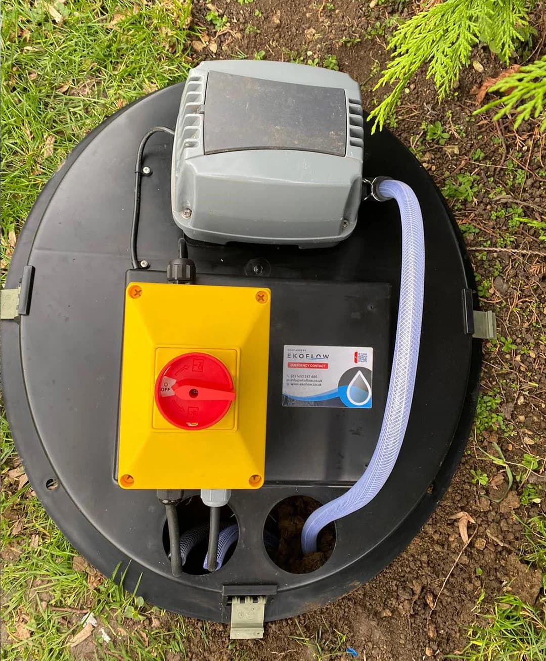 Wastewater treatment equipment with an Ekoflow contact label at a completed installation