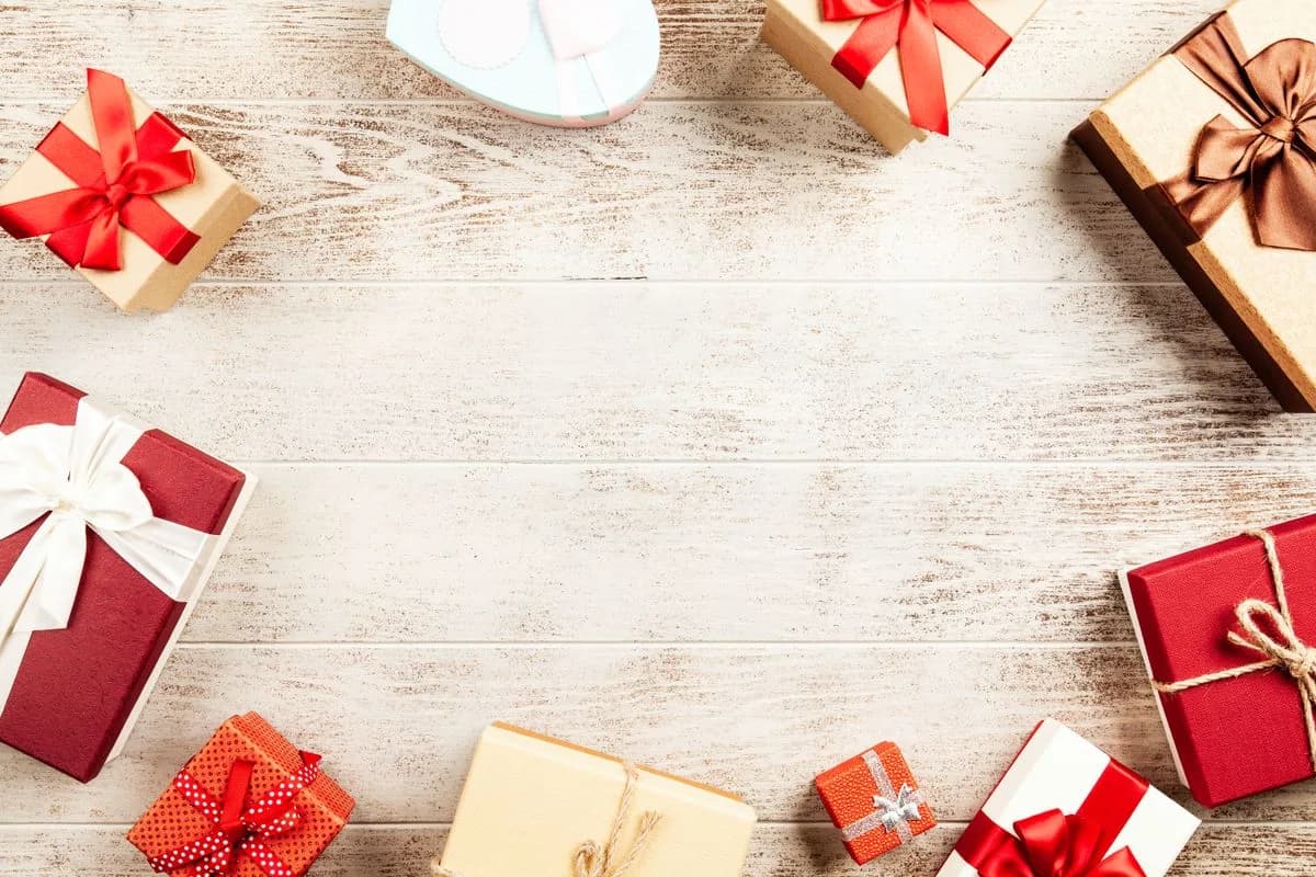 Wrapped gift boxes arranged around a wooden surface