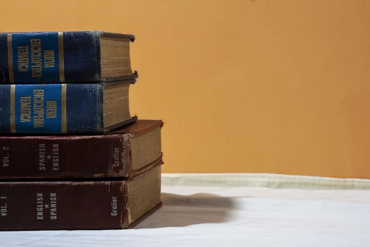 A stack of English and Spanish dictionaries on a table